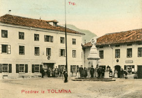 Med najstarejšimi znanimi tolminskimi gostilnami je gostilna Pri Kranjcu, ki jo je od srede 19. stoletja vodila družina Presel. Eden izmed hišnih gospodarjev je v času županovanja leta 1862, ob gradnji  mestnega vodovoda, sredi trga postavil tudi veliko fontano, ki se nahaja tik pred njegovo gostilno (desno) in je Tolmincem še danes v ponos. Levo je poslopje trgovca Vrtovca. (Arhiv Tolminskega muzeja)